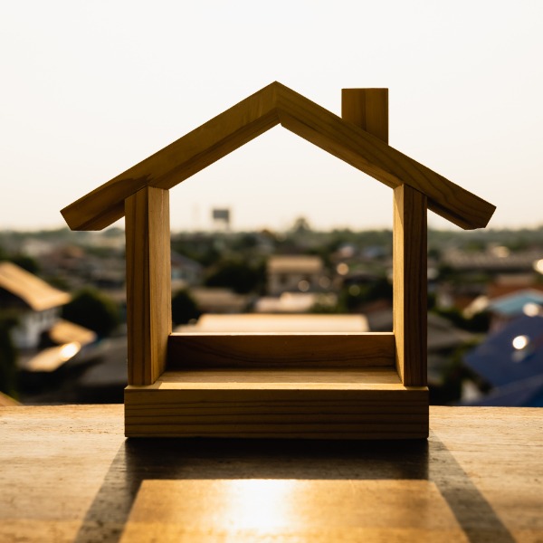 REO services - Small wooden frame of a house.