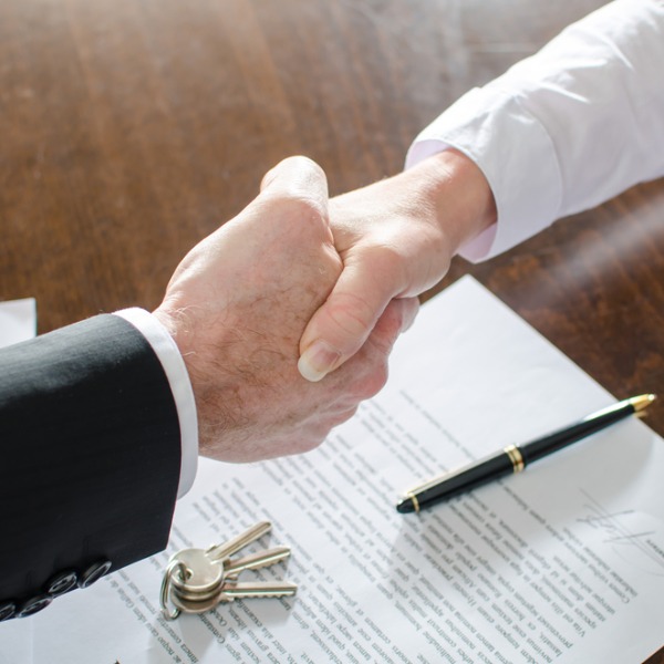 Two hands shaking on a real estate deal - short sales.